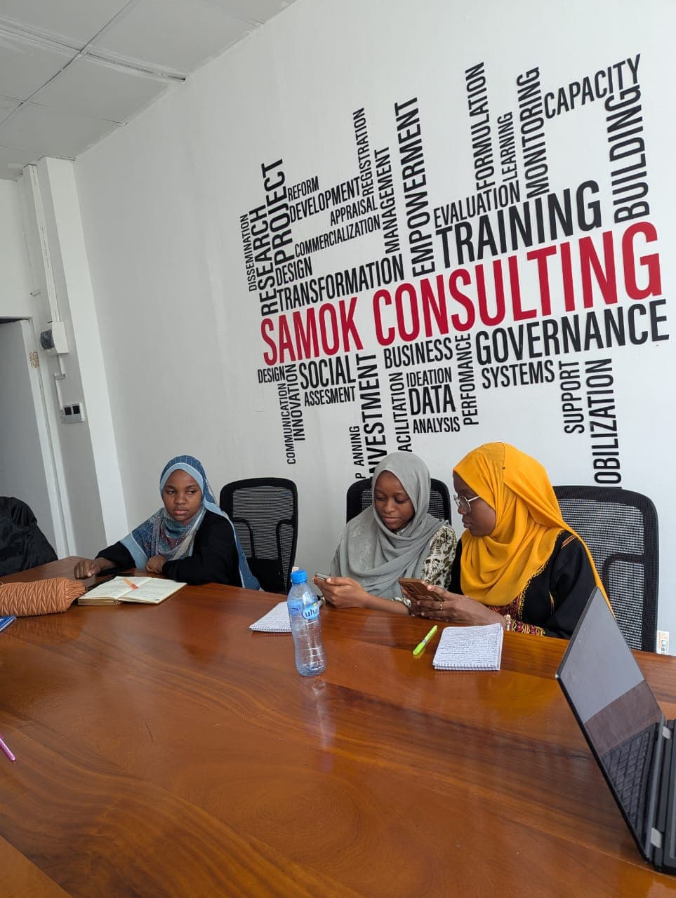 Participants collaborating during a hands-on group exercise in a training hall
